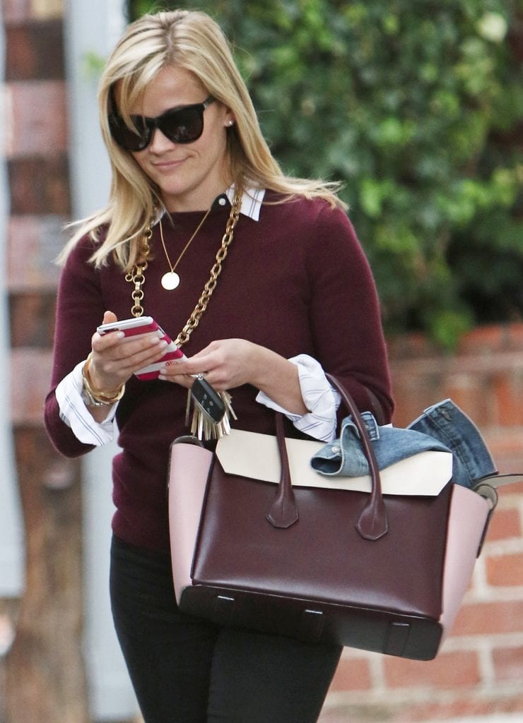 How Reese Witherspoon Wears Maroon Sweater With Black Skinny Jeans