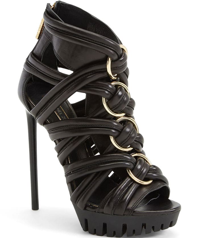 Twisted straps of soft leather further the rocker edge of a sky-high stiletto sandal grounded by a lugged sole