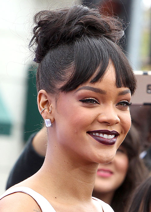 Rihanna's dark lipstick and piled-high updo with bangs