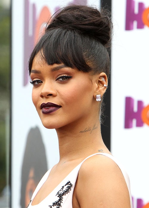 Rihanna's neck, shoulder, and clavicle tattoos peeking out from her dress's scoop neckline