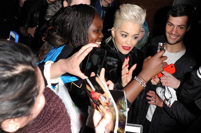 Rita Ora takes selfies with fans