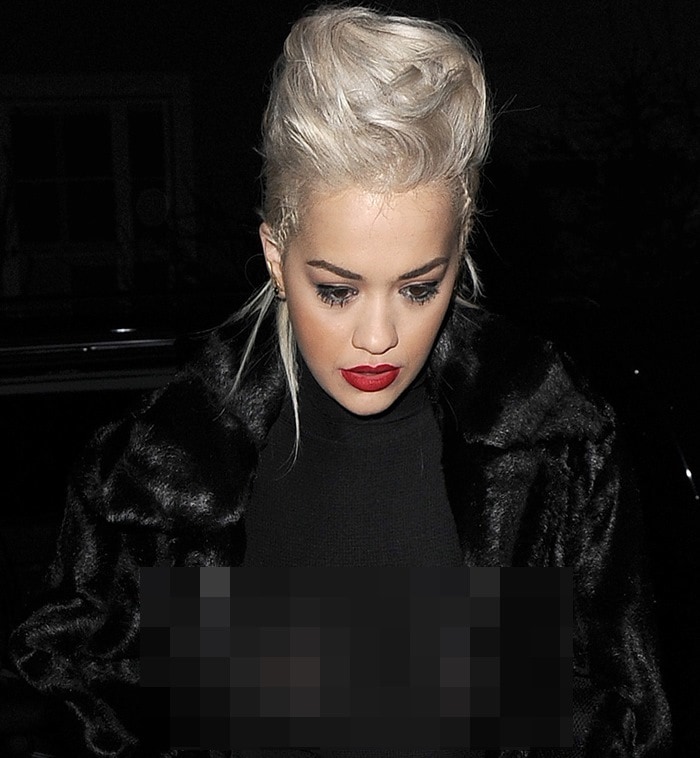 Rita Ora arrives home, but makes a huge wardrobe malfunction, by allowing her jacket to pop open, revealing her breasts, underneath a see-through top on March 25, 2015