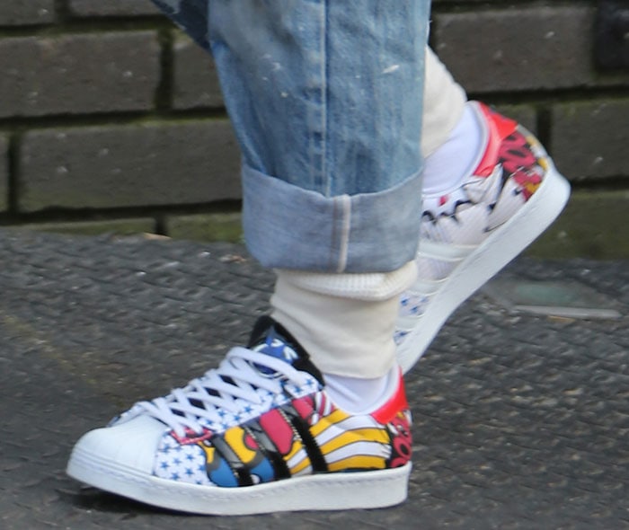 Rita Ora’s Adidas Superstar sneakers from her “Super” collection feature bold pop-art graphics, star motifs, and comic book-inspired panels that turn every step into a statement