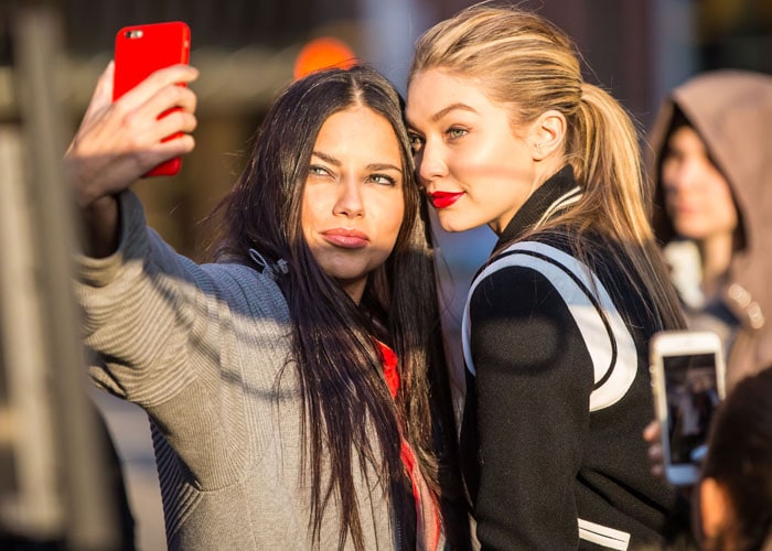 Adriana Lima shooting for Maybelline with fellow model Gigi Hadid on the streets of New York on April 21, 2015