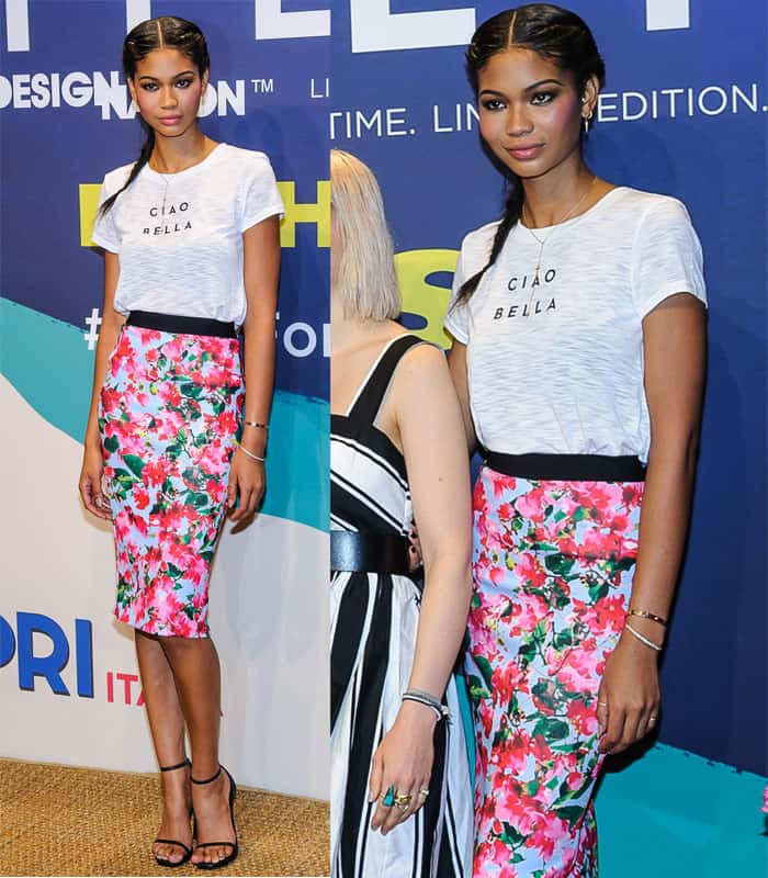 Chanel Iman pairs a floral midi skirt with a slogan T-shirt and black ankle-strap sandals at the Milly for DesigNation collection launch