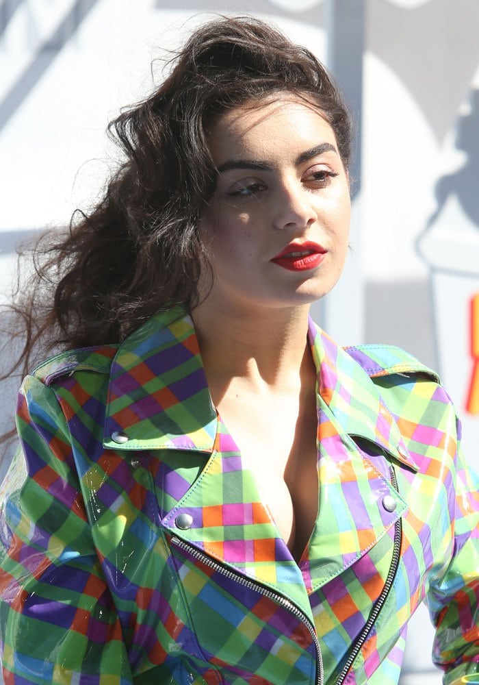 Charli XCX in a colorful patent trench coat by the crazy Jeremy Scott