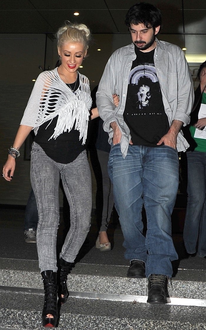 Christina Aguilera and her husband, producer Jordan Bratman, walk arm-in-arm