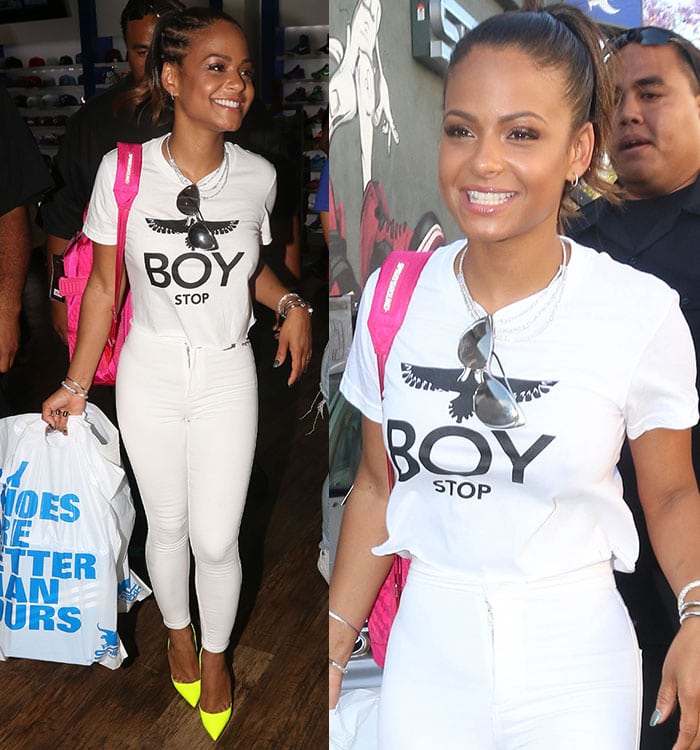 Christina Milian flashing her pearly teeth while carrying her bulging shopping bags