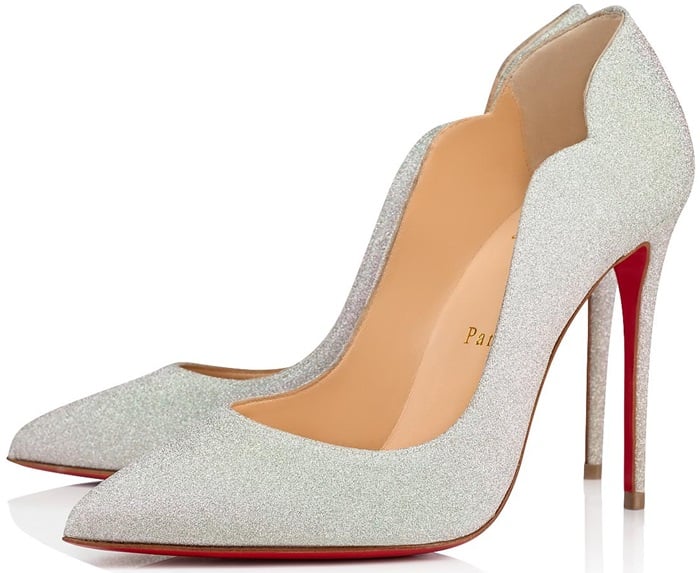 A curvy, scalloped counter and willowy stiletto heel dial up the drama on a pointy-toe pump finished with that iconic red sole