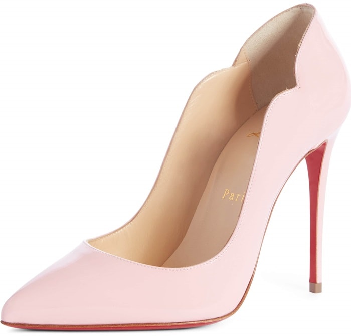 A curvy, scalloped counter and willowy stiletto heel dial up the drama on a pointy-toe pump finished with that iconic red sole