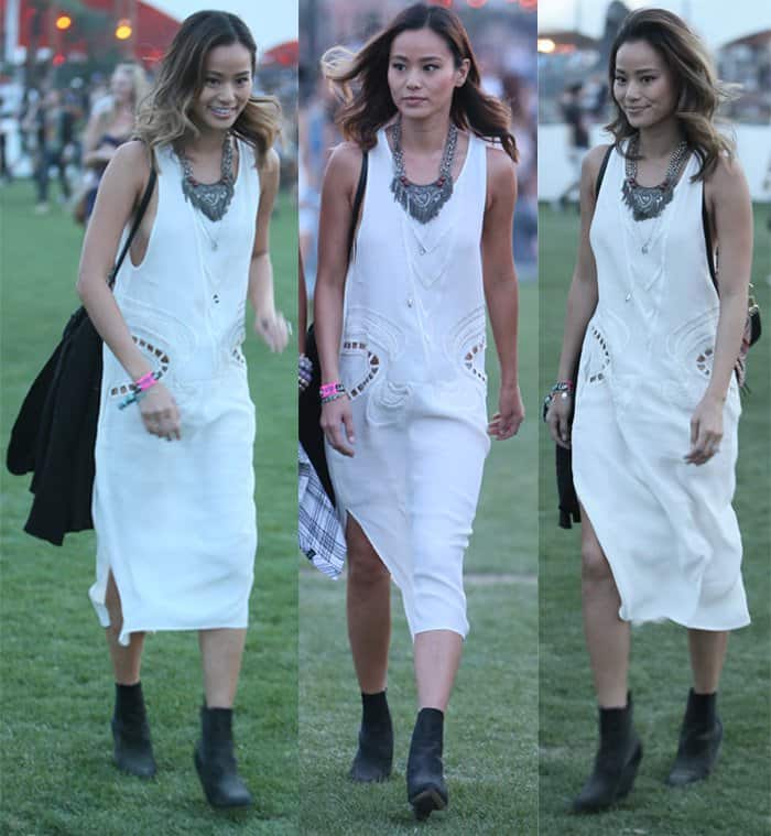 Jamie Chung showcases her festival style in a shapeless midi white dress paired with statement accessories and black booties at Coachella 2015