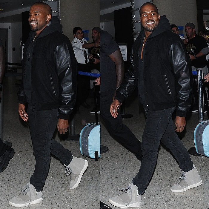 Kanye West flashing a rare smile at the paparazzi