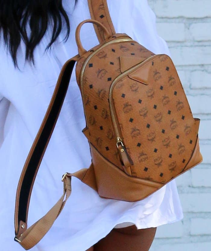 Karrueche Tran complements her casual look with a stylish cognac MCM backpack