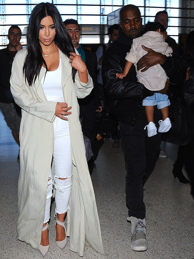 Kim Kardashian, Kanye West, and their daughter, North, catching a flight out of the Los Angeles International Airport