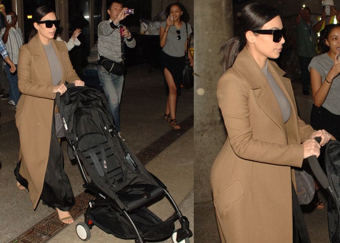 Kim Kardashian pushing a black baby stroller