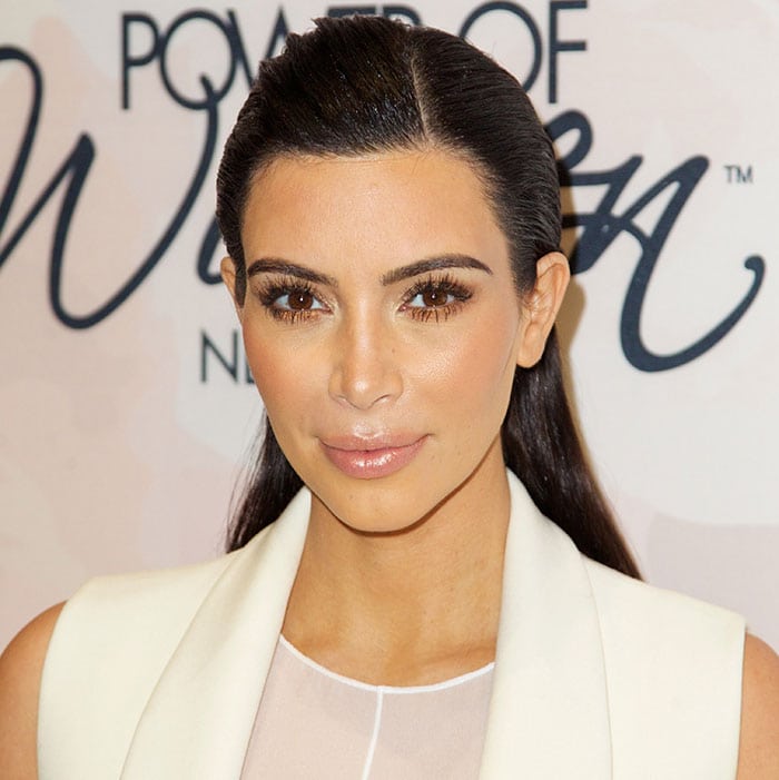 Kim Kardashian wore her hair slicked back with a side part