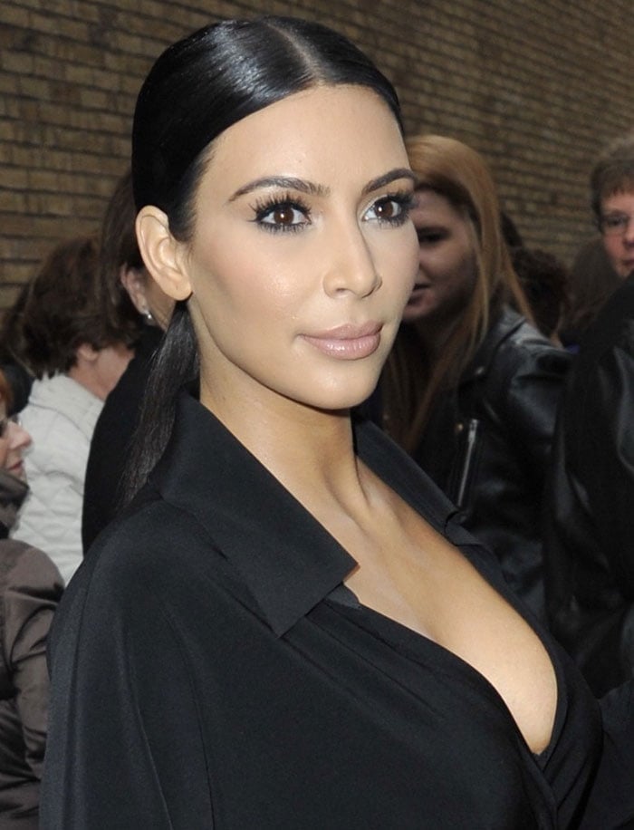 Kim Kardashian's raven hair was pulled back into a center-parted low ponytail