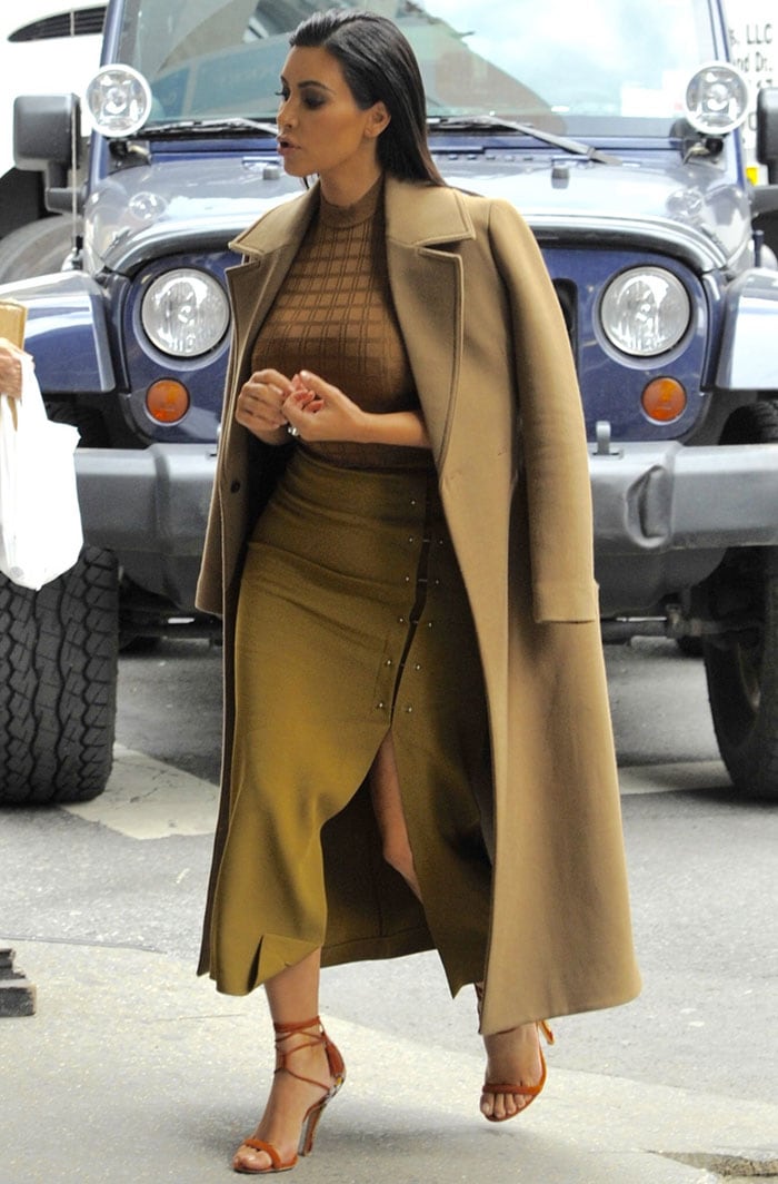 Kim Kardashian's olive green skirt with a thigh-high slit and some unusual pin details