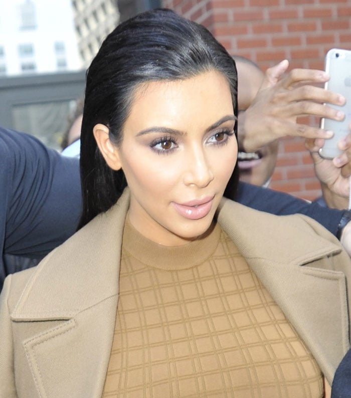Kim Kardashian wore her raven hair in a slicked-back style