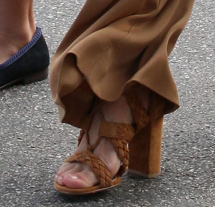 Kourtney Kardashian steps out in Gianvito Rossi's "Jimi" braided sandals, effortlessly complementing her wide-leg trousers with a chic and neutral-toned ensemble