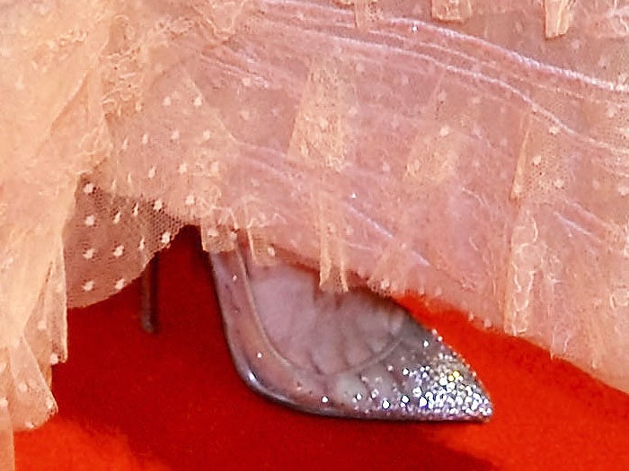 Closeup of the Christian Louboutin "Follies" strass mesh pumps on Lily James' feet