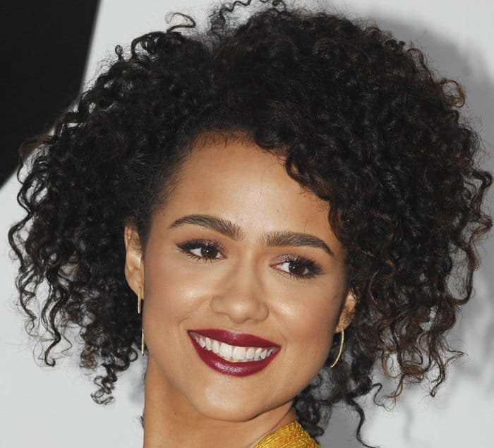 Nathalie Emmanuel's eyes sparkle with a vibrant and captivating allure, perfectly complemented by her radiant smile