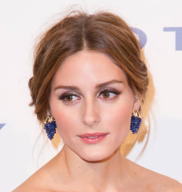 Olivia Palermo exudes elegance with her soft updo and statement blue earrings, complementing her radiant makeup at the 9th Annual Delete Blood Cancer Gala