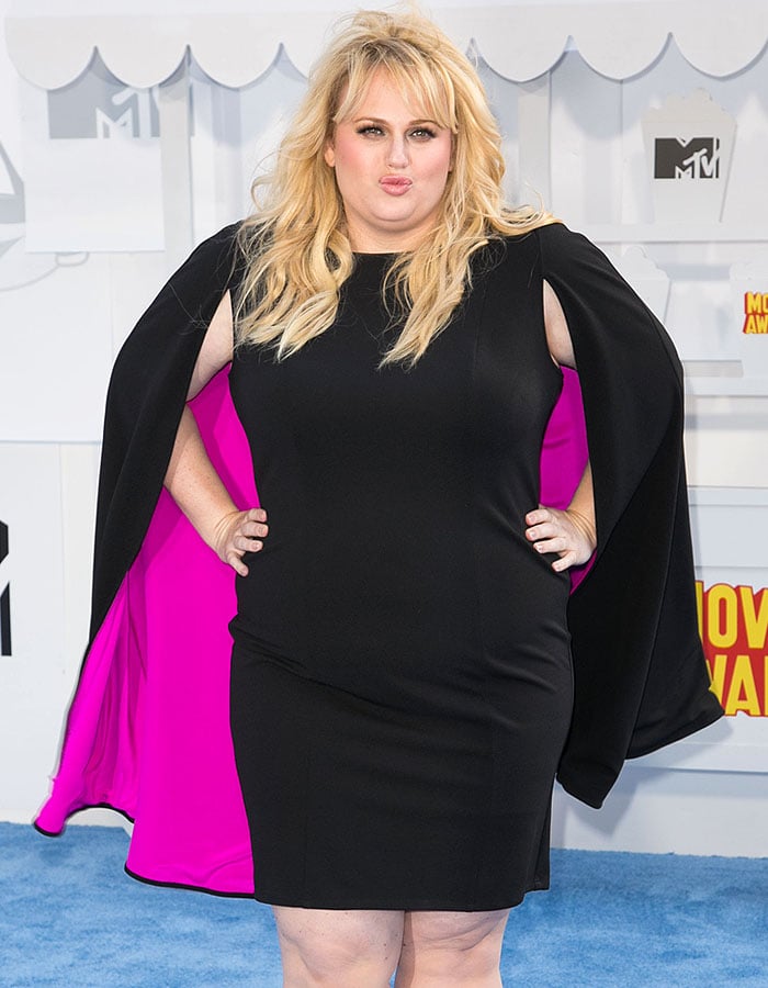 Rebel Wilson working the cameras as a female superhero with wings
