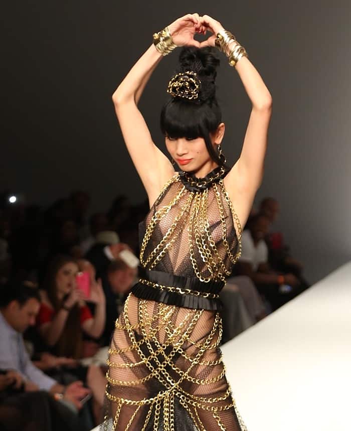 ai Ling's remarkable dress was adorned with sheer fabric intricately embellished with chain links at the 2015 Los Angeles Style Fashion Week "A Night with Haiti" show