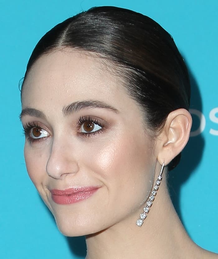 Emmy Rossum gracefully showcases her Martin Katz dangling diamond earrings, adding a touch of timeless elegance to her red carpet look