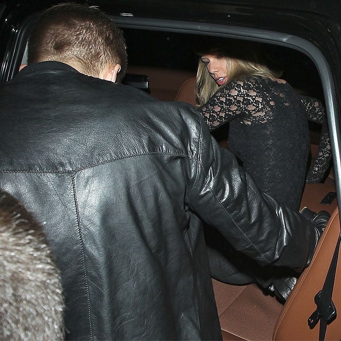 Taylor Swift and Calvin Harris safely getting into their car and out of the paparazzi mob