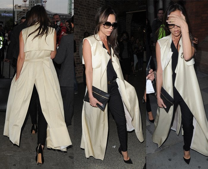 Victoria Beckham wearing tapered pants, cleavage-baring top and a coat from Saint Laurent