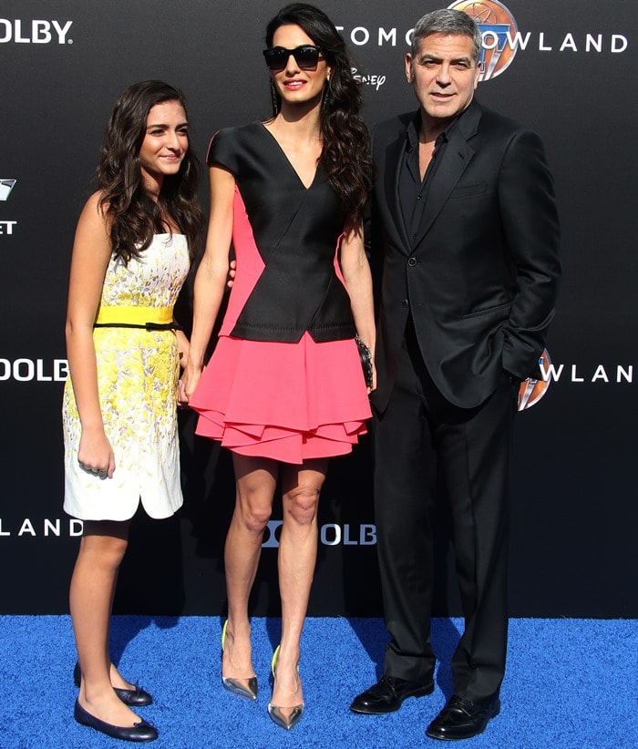 Mia Alamuddin, Amal Clooney and George Clooney pose for photos on the blue carpet