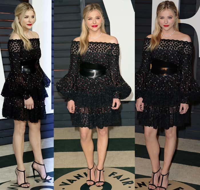 Chloë Grace Moretz attended the Vanity Fair Party wearing an Alexander McQueen Pre-Fall 2015 black lace dress with mini flowers, a tiered skirt, bell accent sleeves, and a black leather waist belt