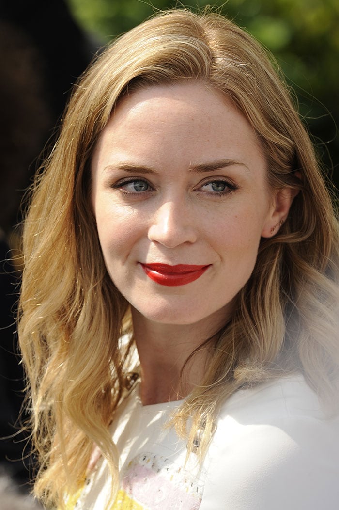 Emily Blunt wore her short blonde hair down in loose waves and opted for a bright red lip shade