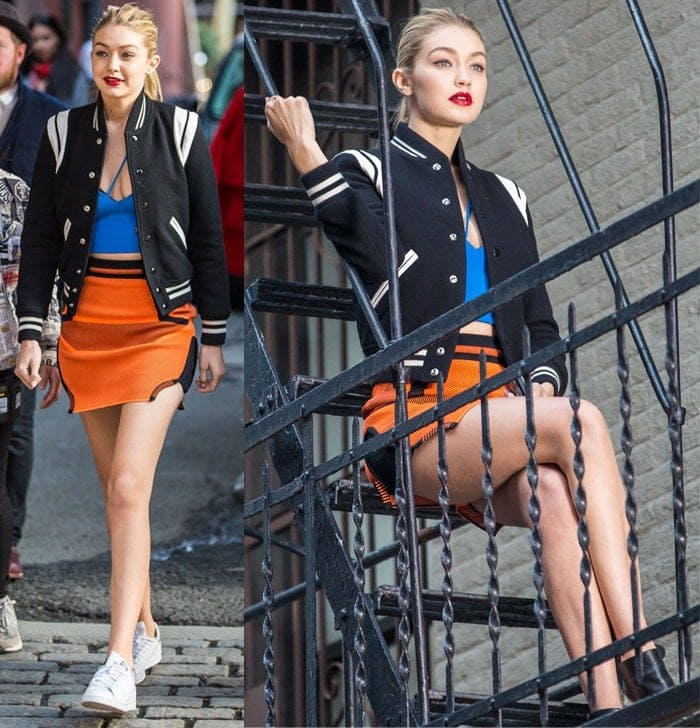 Gigi Hadid dazzles in a dynamic street-style photoshoot in New York, sporting a vibrant orange skirt and the iconic Saint Laurent bomber jacket