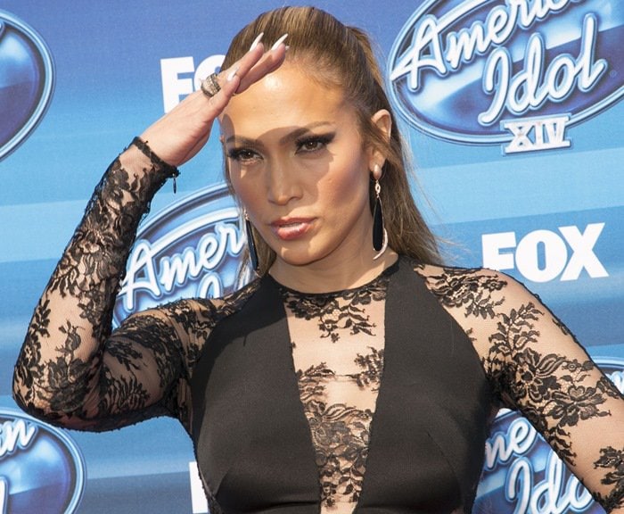 Jennifer Lopez wears a black dress with lace sleeves and cutout details at the American Idol Season 14 finale