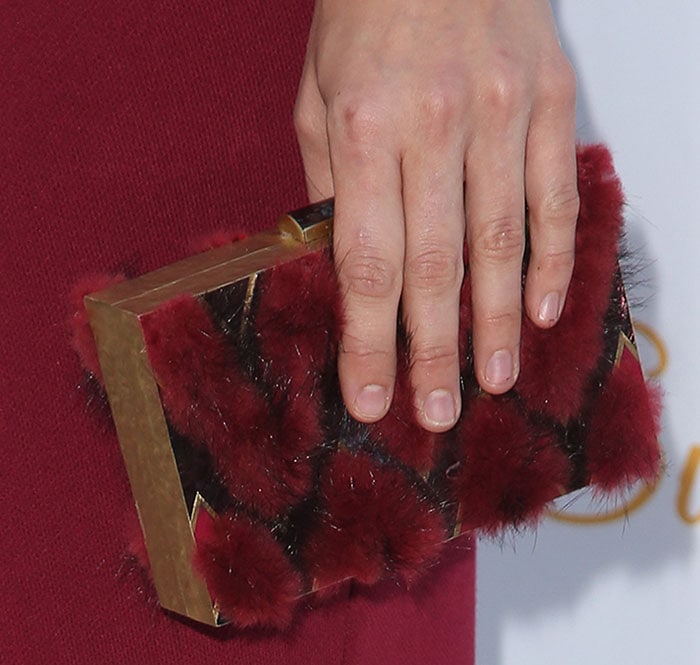 Katharine McPhee toting a box clutch featuring furry red details