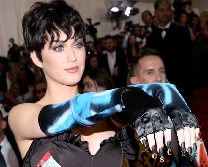 Katy Perry rocking a black Moschino dress and a tousled pixie hairstyle