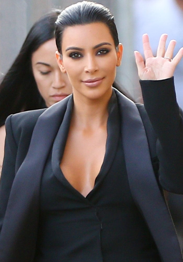 Kim Kardashian slicked her hair back and put on her trademark smoky eyes and nude lips