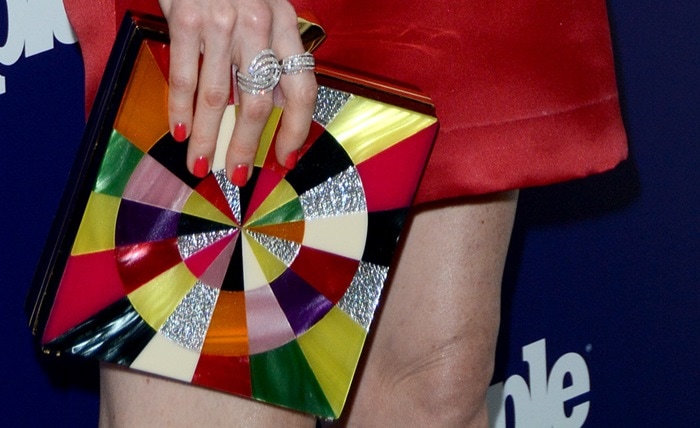 Darby Stanchfield totes a Kotur "Fitzgerald Perspex Swirl" clutch