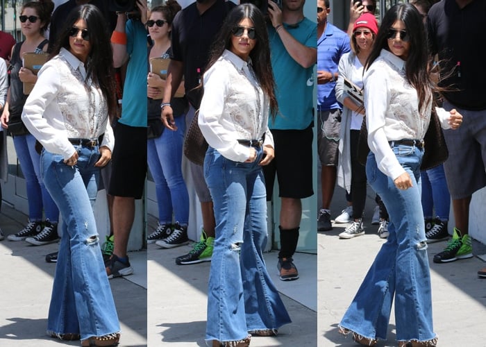 Kourtney Kardashian styled her jeans with a Mason by Michelle Mason silk lace front blouse