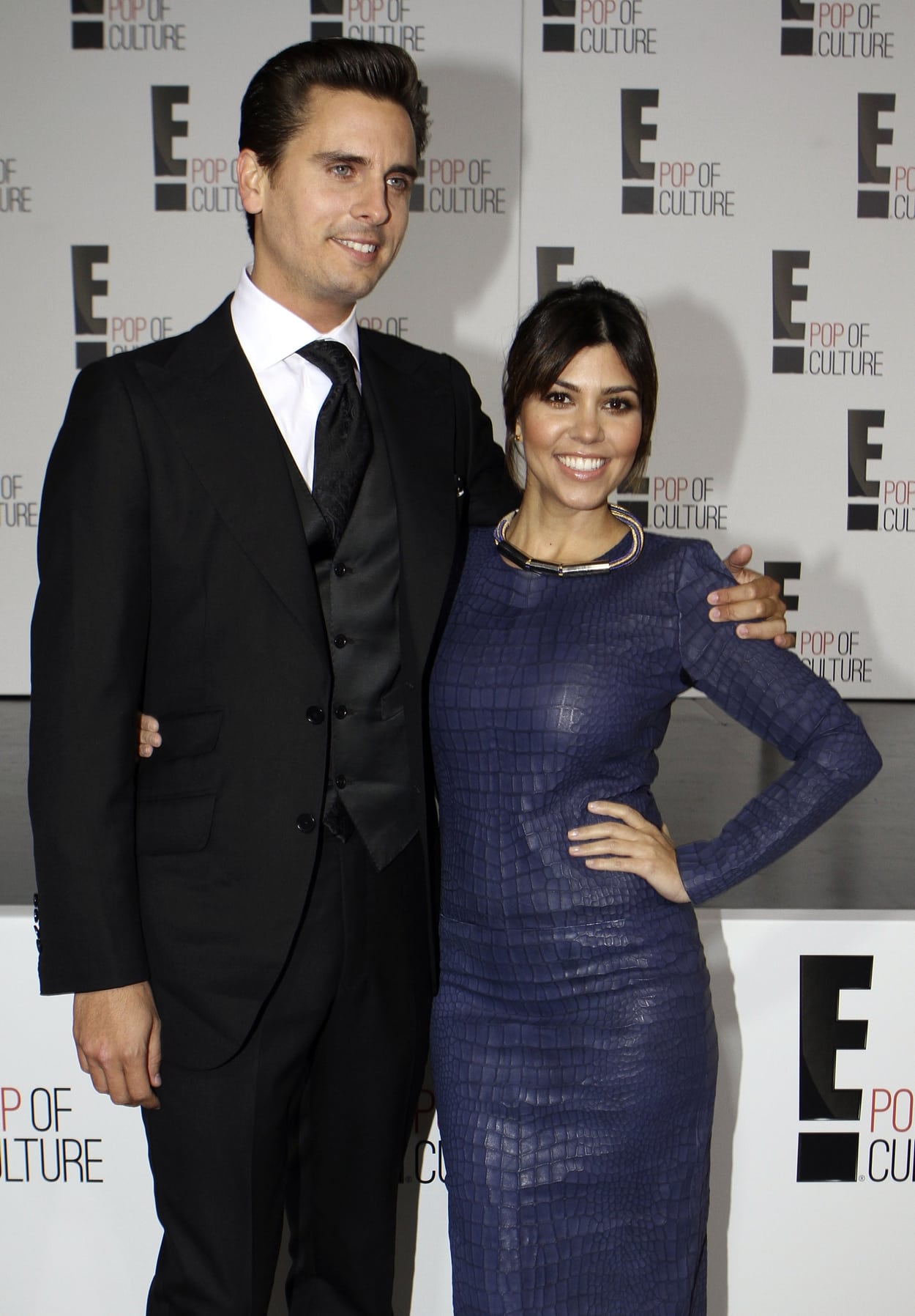 Kourtney Kardashian in a blue crocodile dress and Scott Disick attend the E! 2013 Upfront