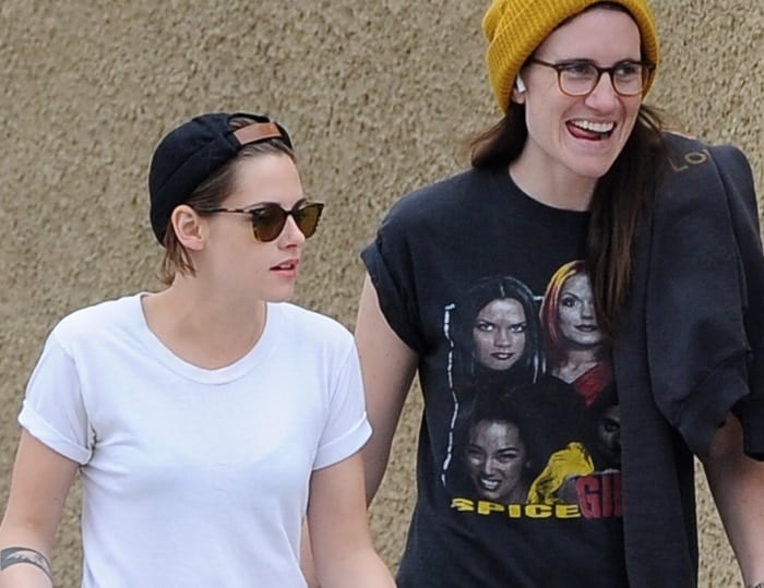 Kristen Stewart wears a backward cap and brown "LA Coen Sun" sunglasses