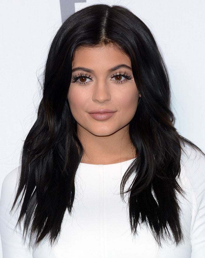 Kylie Jenner with center parting and soft curls cascading over her shoulders