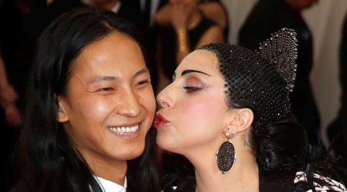 Lady Gaga shares a playful moment with designer Alexander Wang, showcasing her dramatic makeup and bejeweled headpiece, at the 2015 Met Gala