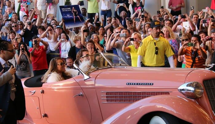 Mariah Carey arrives in a classic pink convertible, greeted by an excited crowd at her Las Vegas residency event