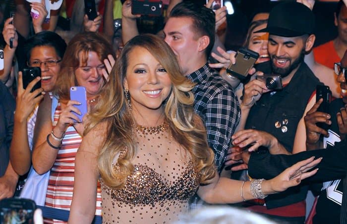 Mariah Carey captivates the crowd with her radiant smile and glamorous gold-embellished gown at her Las Vegas residency event