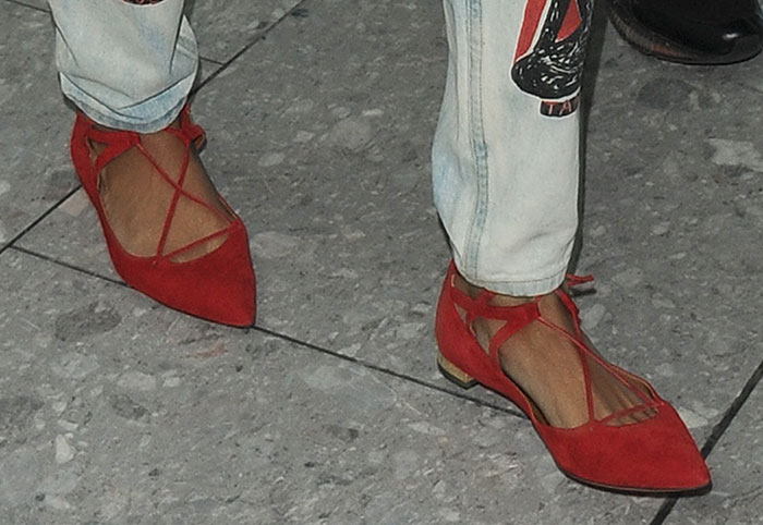 Rihanna wears red flats with ankle ties and gold-tone aglets