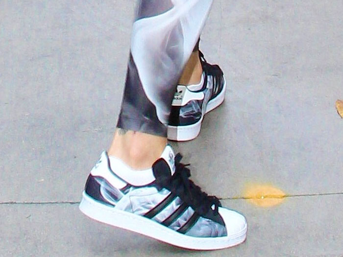 Rita Ora shows off the slightest hint of an ankle tattoo in her adidas sneakers